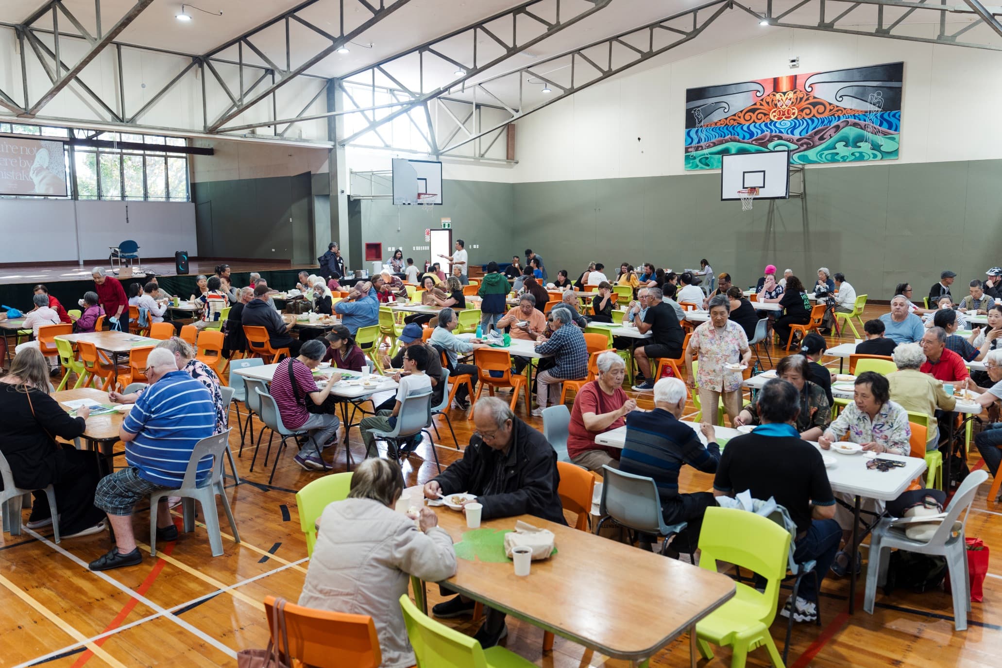 Wide shot of LIFE Community Kitchen with diners sitting at tables eating their meal
