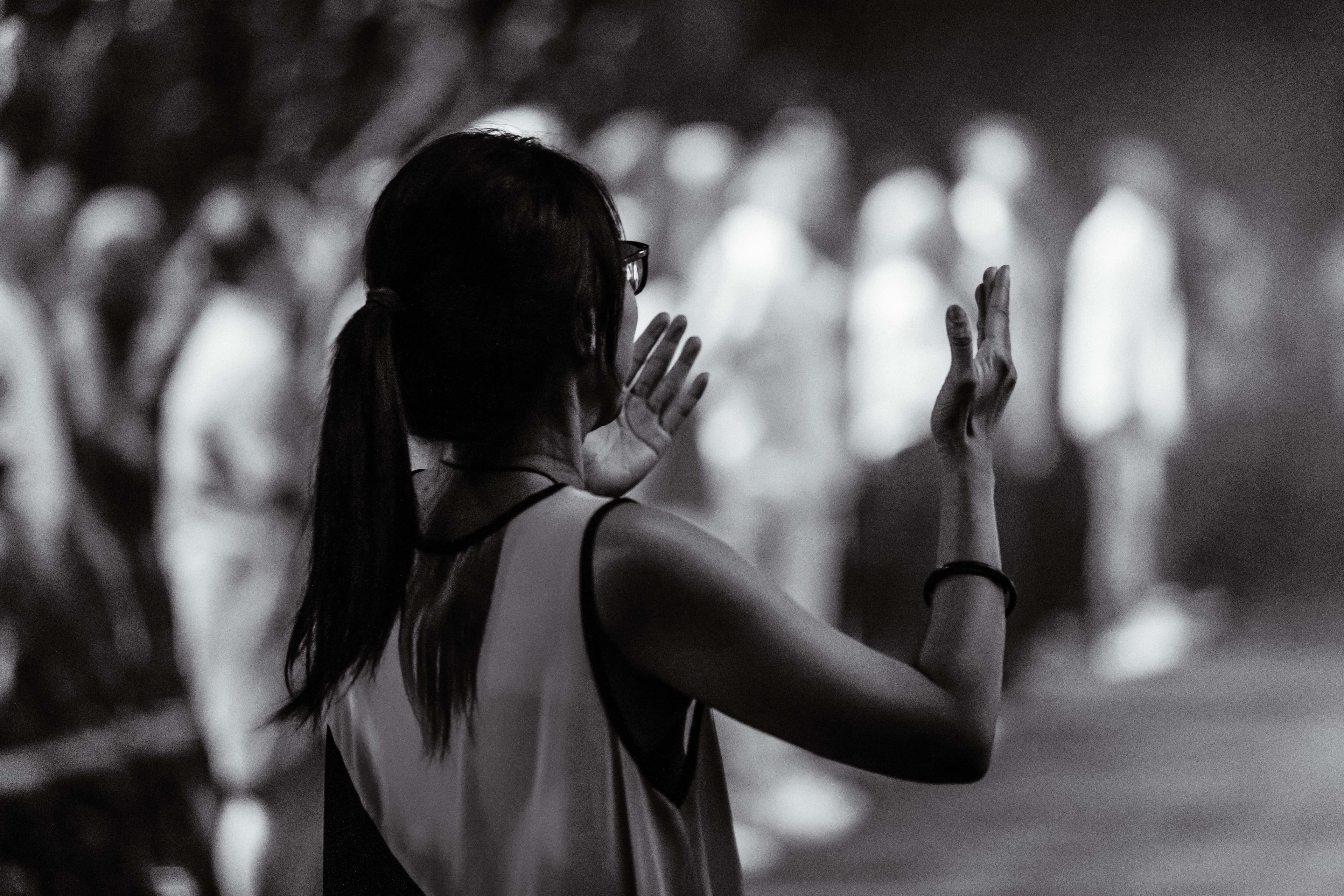 Woman in worship with her hands raised