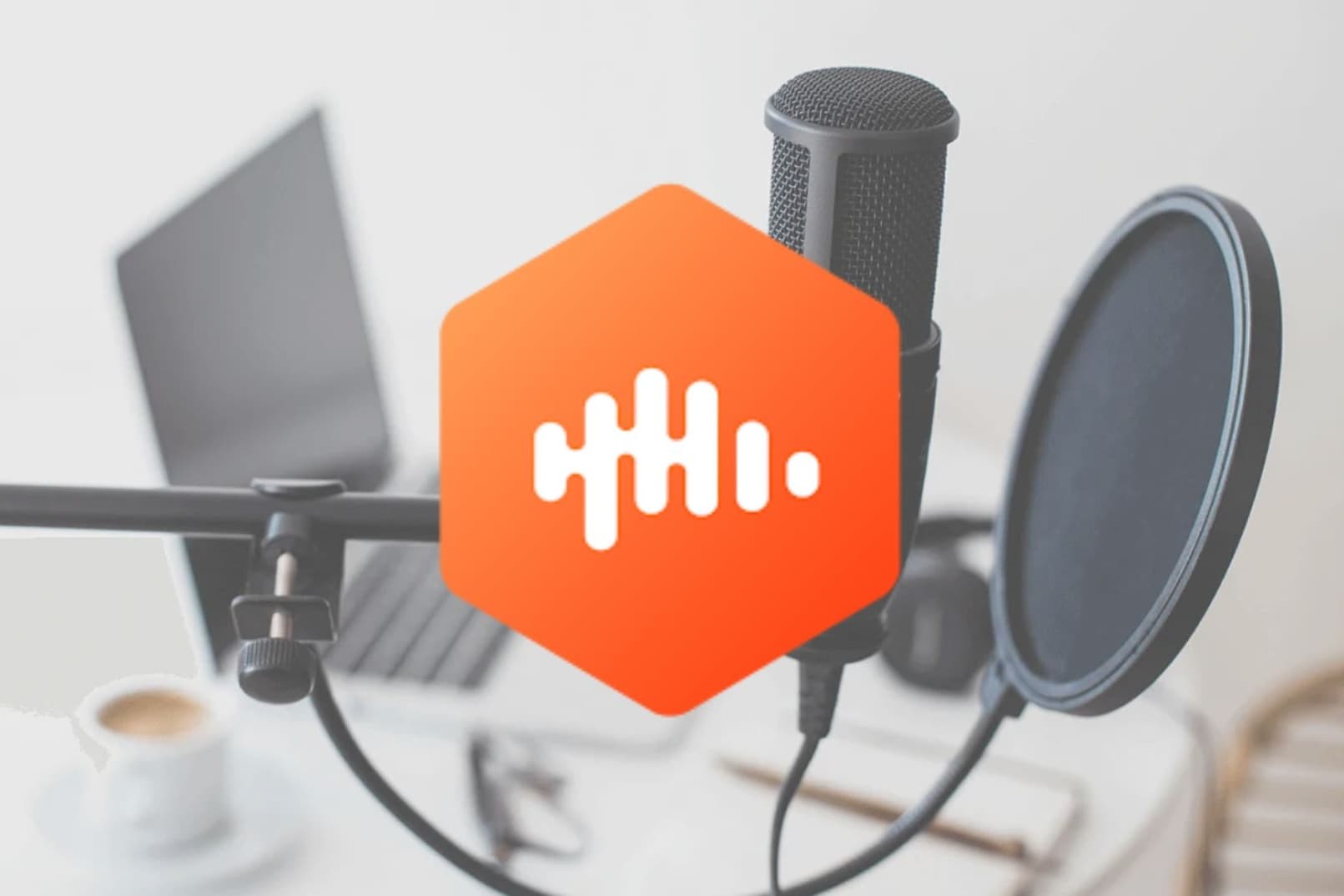 Castbox orange logo overlaid on image of podcast set up with microphone and laptop on a desk