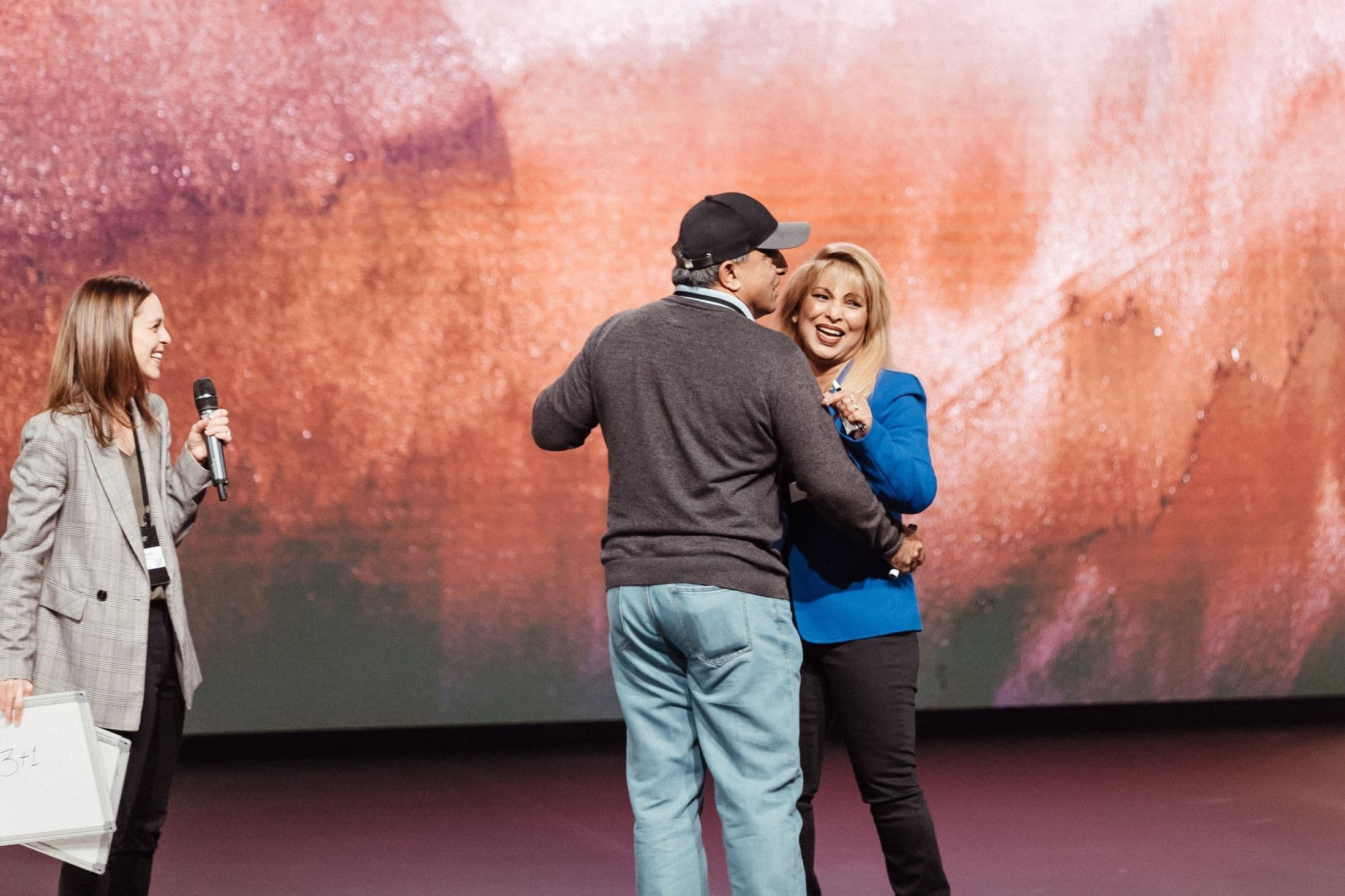 Two people dancing on stage at Central campus at the Marriage retreat
