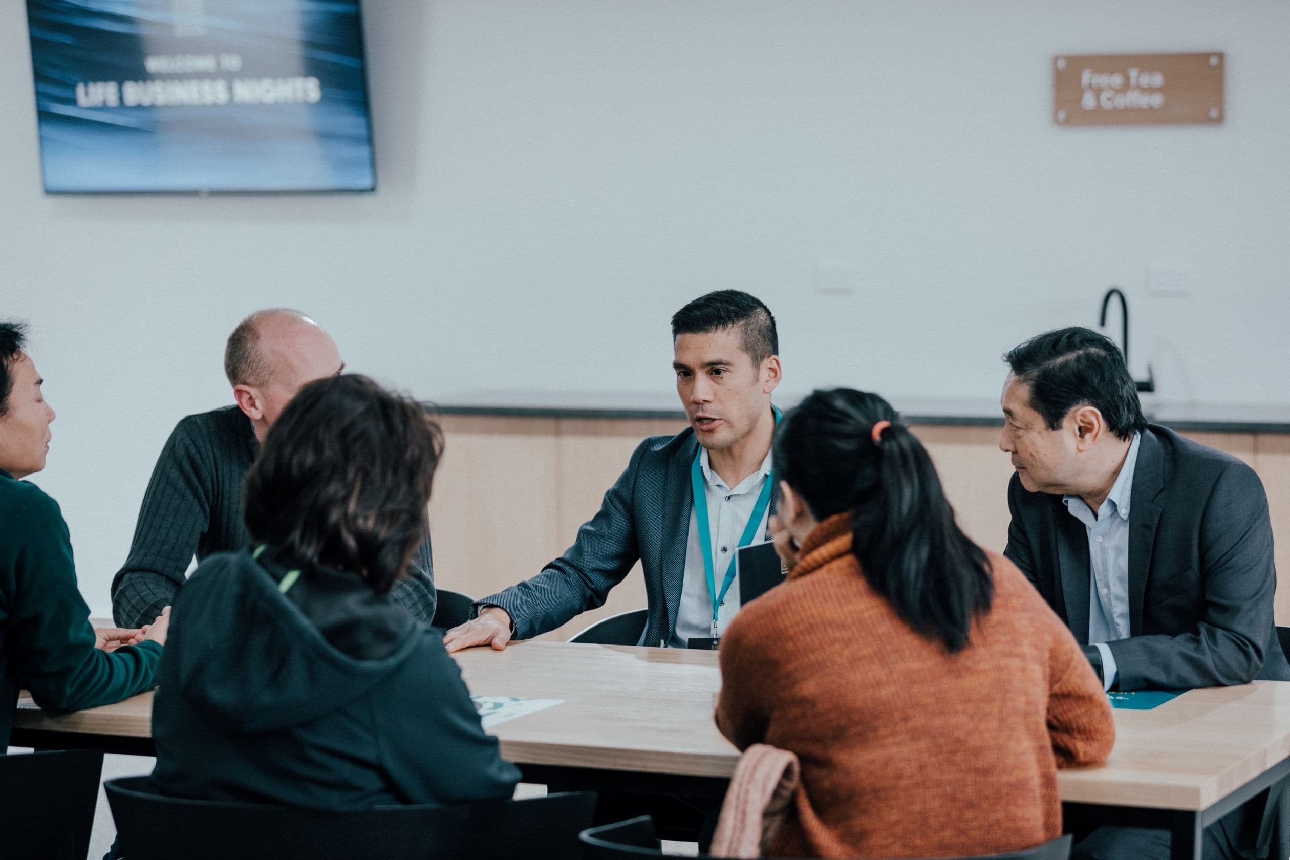 A group of people listening to an experience business leader