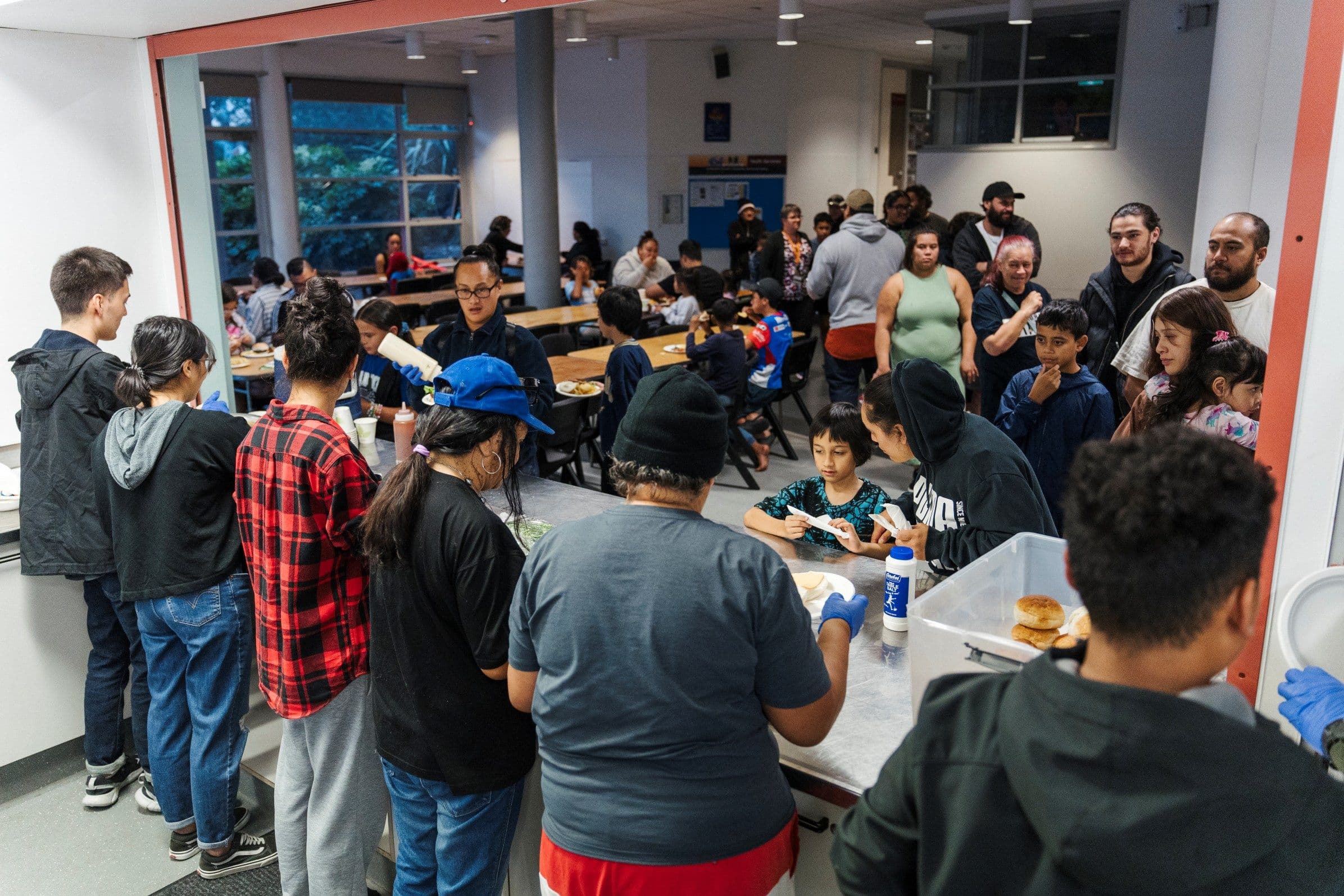 Wide shot of the LIFE Community Kitchen in Manurewa with volunteers serving food to diners