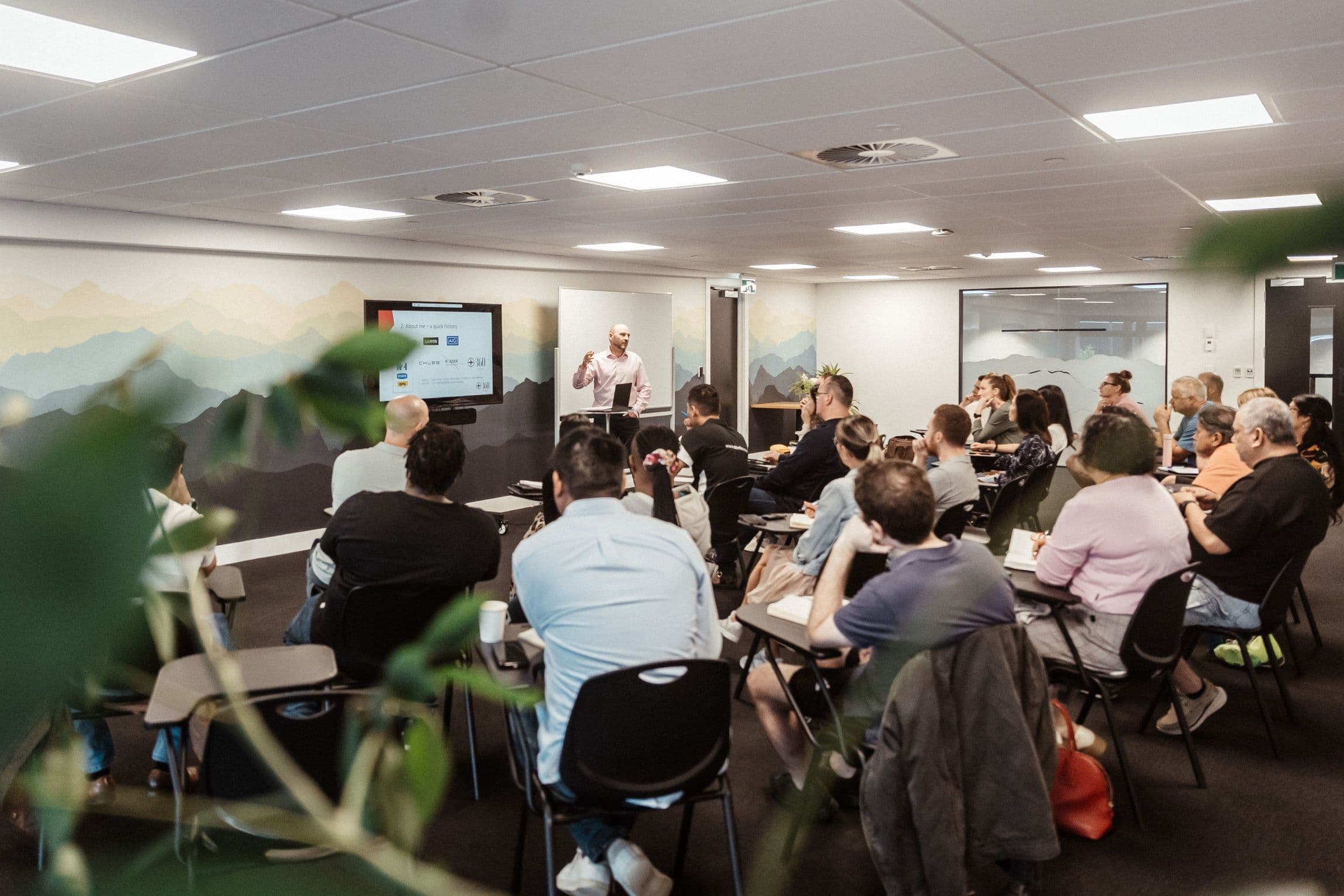 A man presenting to a group of people at the Alpha course