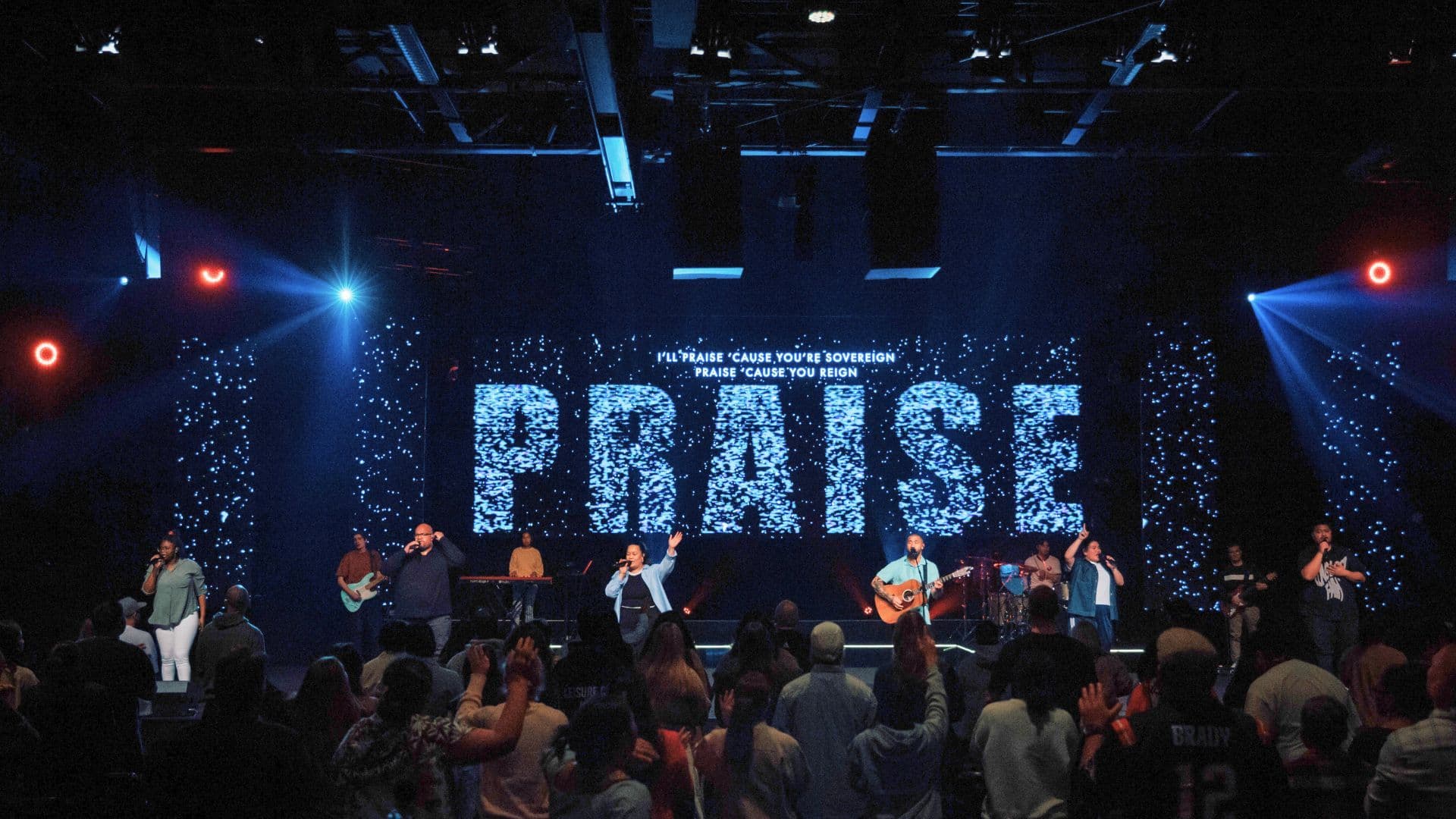 South Auditorium with PRAISE on the screen behind the worship team on stage